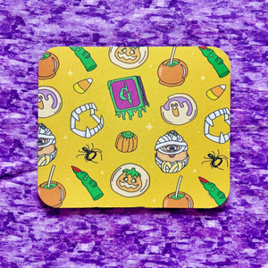 Small rectangular mousepad with 90s Halloween pattern on a purple textured background