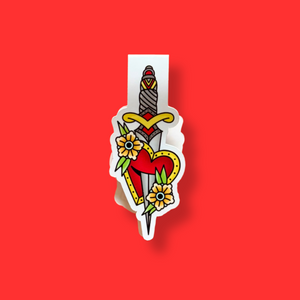 Magnetic bookmark with heart and sword design on a red background