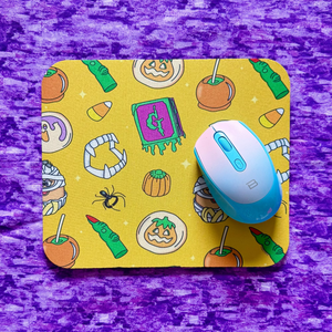 Mouse pad with Halloween-themed design on a purple surface