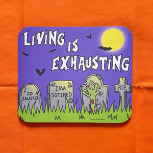 Halloween-themed coaster with 'Living is Exhausting' text on an orange surface.
