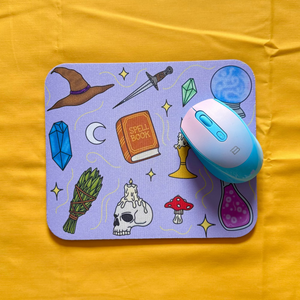 Mouse pad with witch cartoon designs.