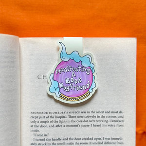 Crystal ball bookmark on a page of a book with an orange background