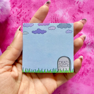 Hand holding a sticky notepad with a 'Dead Inside' tombstone design against a pink background