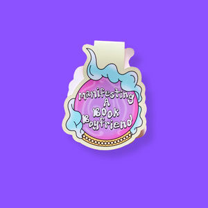 Crystal ball magnetic bookmark with 'manifesting a book boyfriend' text on a purple background