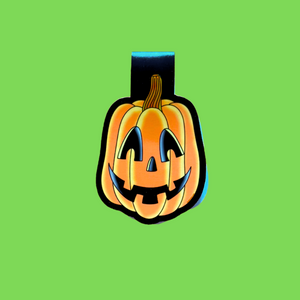 Jack-o'-lantern magnetic bookmark on a green background