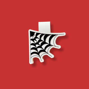 Black and white cobweb magnetic bookmark on a red background